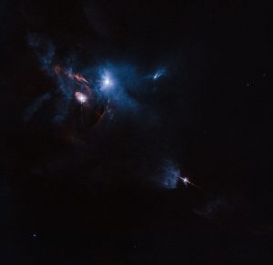 The NASA/ESA Hubble Space Telescope has snapped a striking view of a multiple star system called XZ Tauri, its neighbour HL Tauri and several nearby young stellar objects. XZ Tauri is blowing a hot bubble of gas into the surrounding space, which is filled with bright and beautiful clumps that are emitting strong winds and jets. These objects illuminate the region, creating a truly dramatic scene.